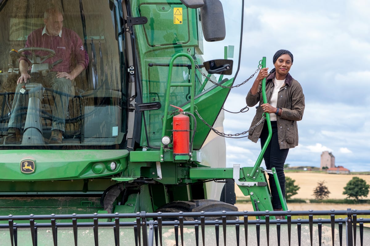 Conservative party leader Kemi Badenoch, climbs aboard a combine harvester during a visit to Balgone Barns Farm, on Balgone Estate in North Berwick.