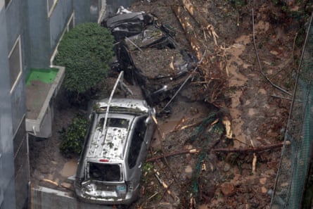 Vehicles lie crushed among the debris after a landslide caused by heavy rains in Geoje