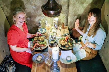 Two women facing each other across a restaurant table