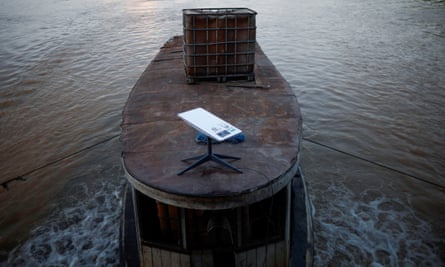 A Starlink satellite antenna placed on the canvas roof of a boat