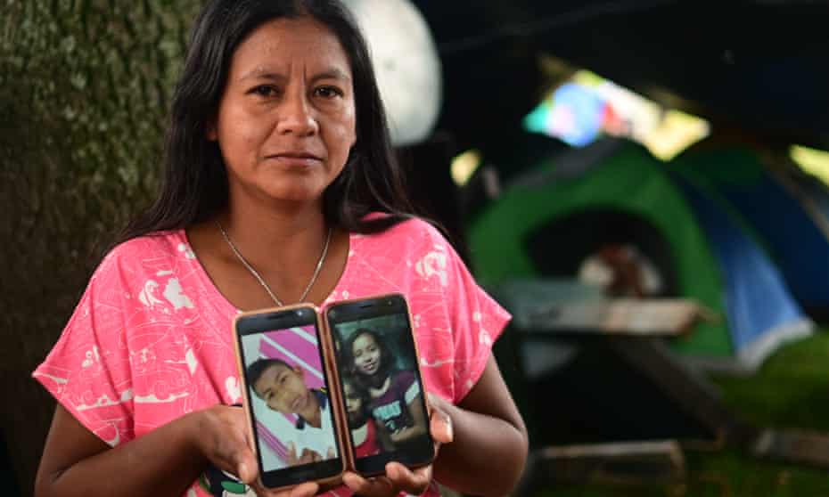 Luzmery Troches with pictures of her son Luis and his sister.