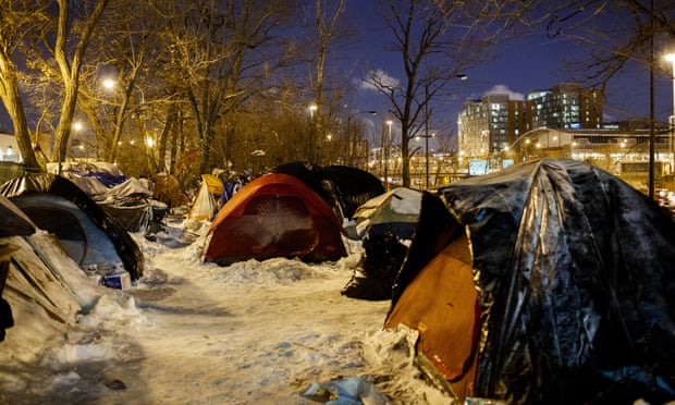 People sleep in tents near a wooded area adjacent to the Dan Ryan Expressway in Chicago on Tuesday.