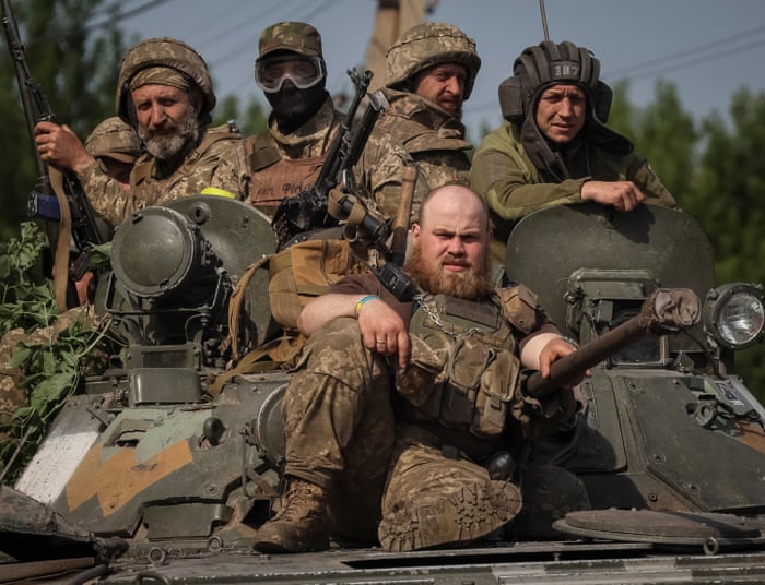 Ukrainian servicemen ride BMP-1 infantry fighting vehicle, amid Russia’s attack on Ukraine, in Donetsk region.