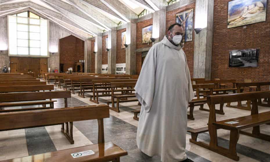 Priest Don Marcello walks in the San Giuseppe church in Seriate, near Bergamo, ahead of Sunday Mass on 14 February 2021.