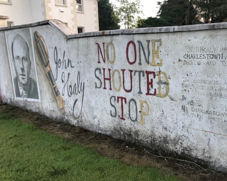 A mural with the words ‘No One Shouted Stop’ on a white wall