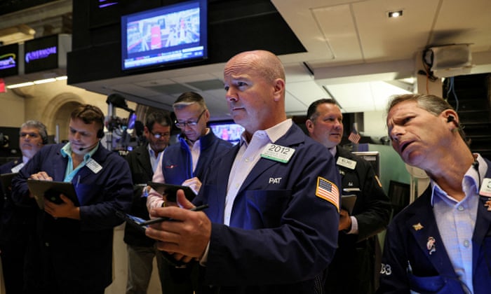 Traders on the floor of the New York Stock Exchange last night.