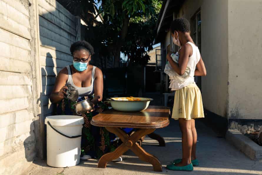 Samantha Murozoki hands a free meal to a young girl