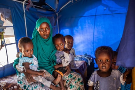 Hani Hashi Aden, 40, sits with her children in her makeshift home in the Xidig IDP camp in Mogadishu.