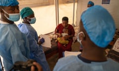 Medical staff treat a woman and her baby for mpox at a health centre in Munigi, the Democratic Republic of the Congo