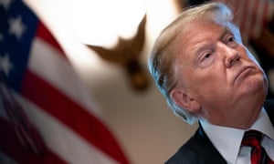 Donald Trump listens during a meeting on border security in the Cabinet Room of the White House.