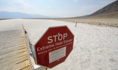 Signage at the salt flats inside Death Valley national park in California warns of extreme heat in June 2021.