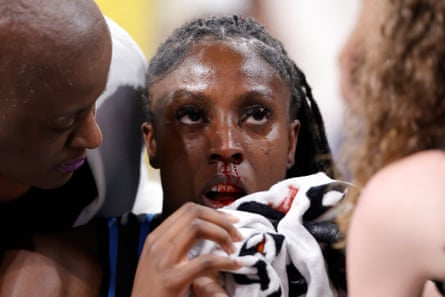 Laeticia Amihere of the Atlanta Dream is tended to by medical staff after a flagrant foul during a 2023 game against the New York Liberty.
