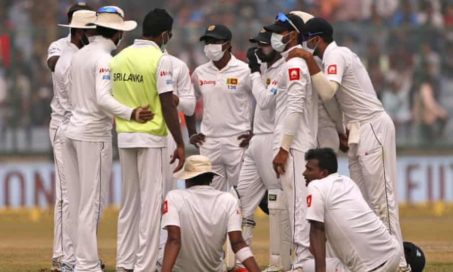 Sri Lanka’s players, wearing anti-pollution masks, speak to each other as the Delhi Test with India was briefly stopped in December 2017 due to the poor air condition.