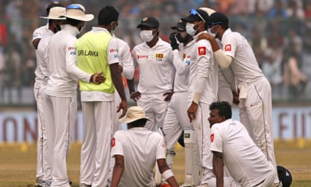Sri Lanka’s players, wearing anti-pollution masks, speak to each other as the Delhi Test with India was briefly stopped in December 2017 due to the poor air condition.