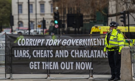 A protest banner in Parliament Square, London, accusing the government of corruption