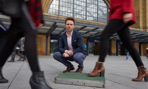 Designer Laurence Kemball-Cook with his Pavegen tile that is designed to convert the kinetic energy generated from peole stepping on it, to electical energy - perfect for areas with lots of human traffic such as railway and airport terminals. King's Cross, London. 25/11/14
