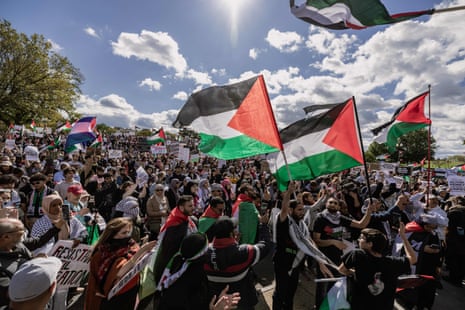 Demonstrators carrying Palestinian flags march past the Washington Monument during a rally on 21 October.