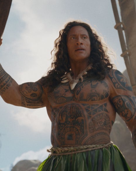 Dwayne Johnson as Maui with traditional body tattoos holds up an object in front of a cloudy sky
