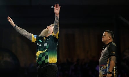 Simon Whitlock hits the winning dart in a thrilling battle with Paolo Nebrida.