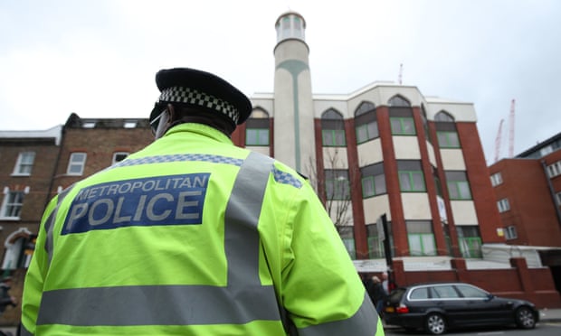 A police officer stands opposite Finsbury Park mosque in London