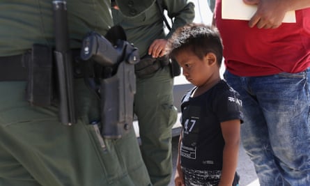 A boy and his father from Honduras are taken into custody by US border agents near the US-Mexico Border on 12 June.