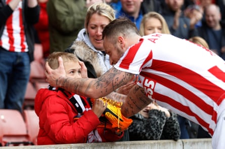 Marko Arnautovic gives his boots to a young fan.