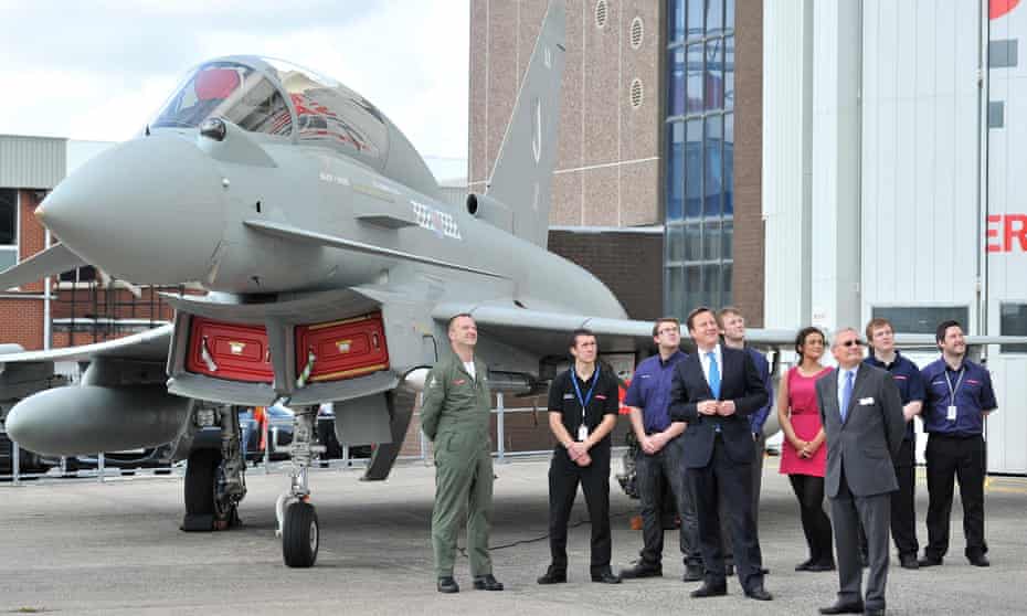 David Cameron observes work on a Eurofighter Typhoon during a visit to BAE Systems in Warton, Lancashire.