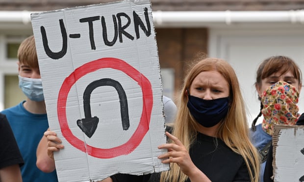 A student holds a placard reading ‘U-turn’ as she takes part in a protest march in Codsall near Wolverhampton.