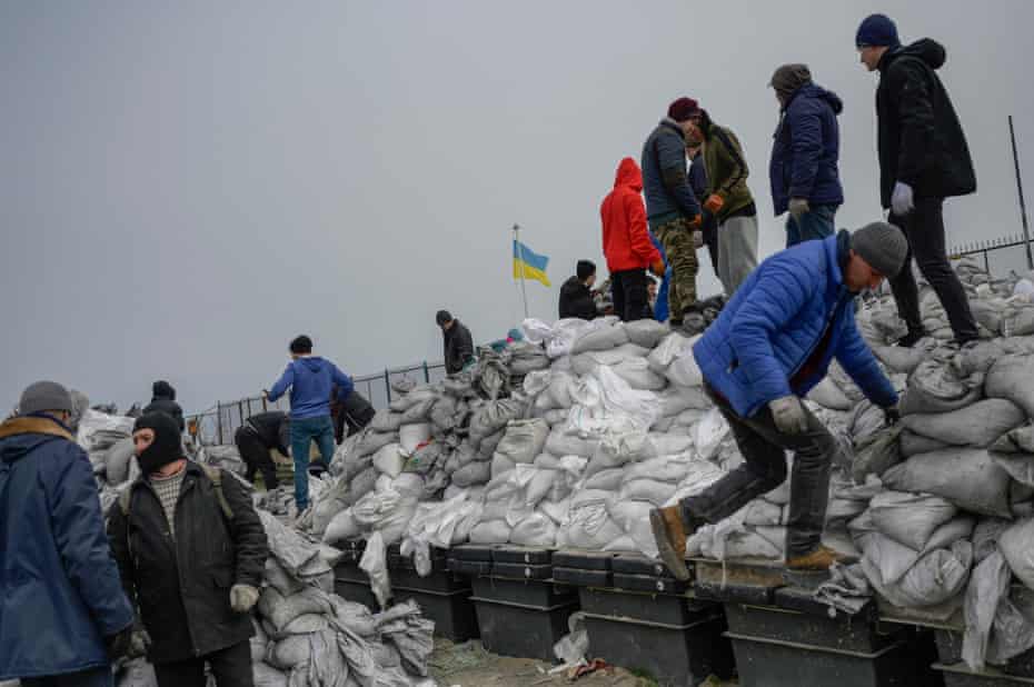 Citizens fill bags with sand
