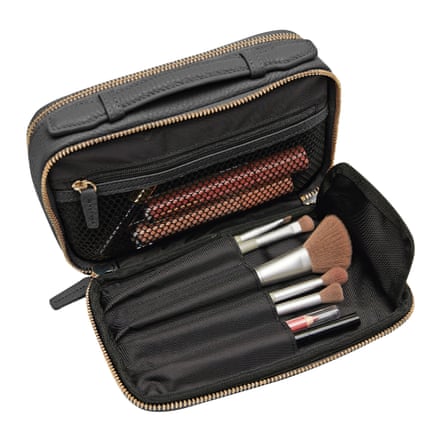 Makeup brushes inside compact black leather bag