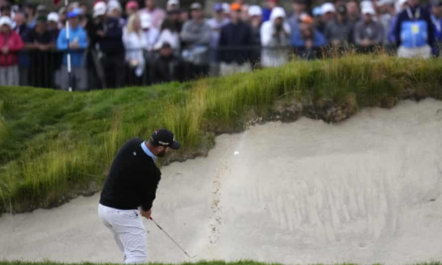 Jon Rahm comes a-cropper on the 18th, hitting the edge of the bunker when playing out, leading to a double bogey