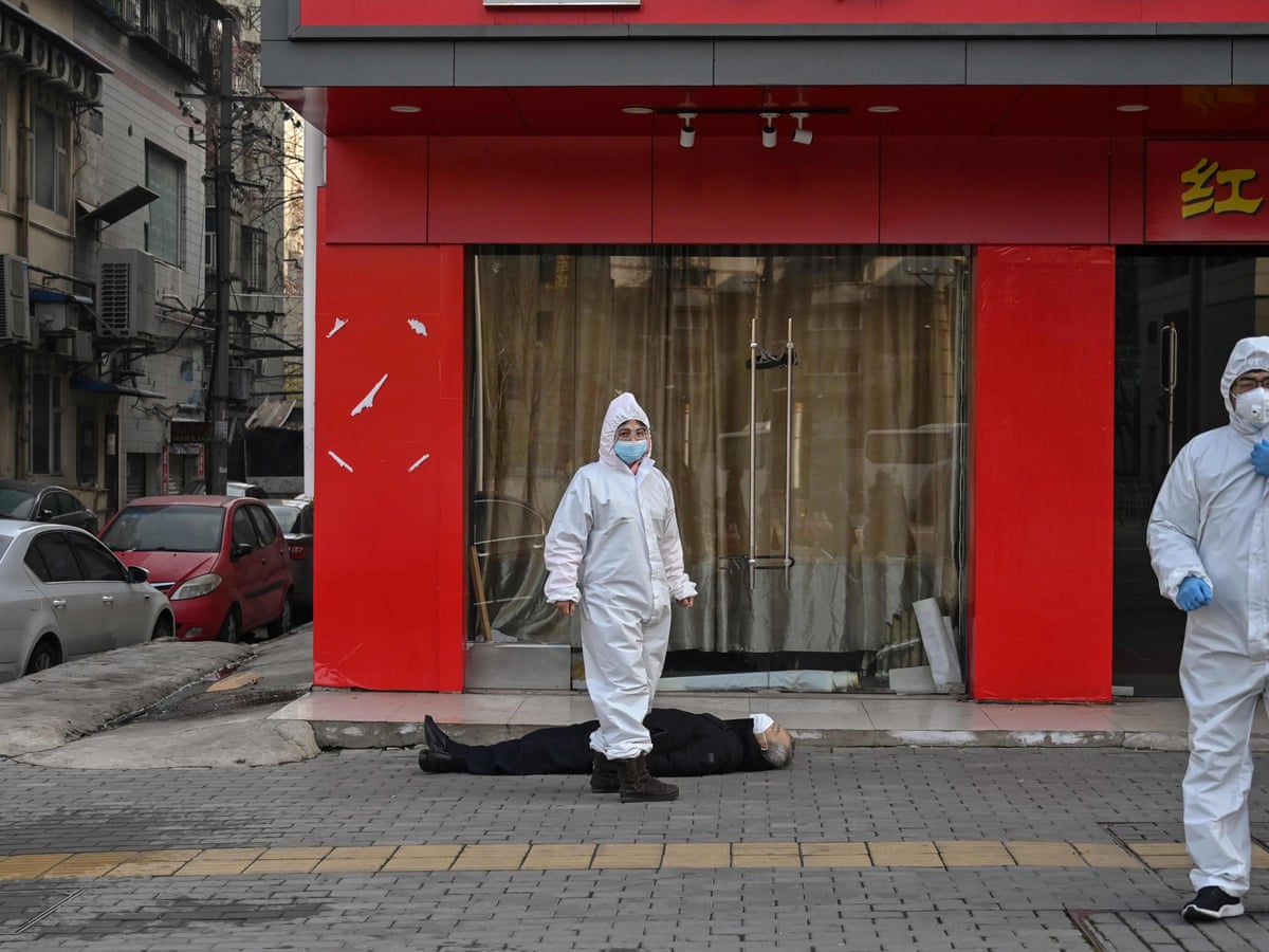 A man lies dead in the street: the image that captures the Wuhan coronavirus  crisis | Coronavirus | The Guardian