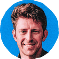 man smiling against blue background