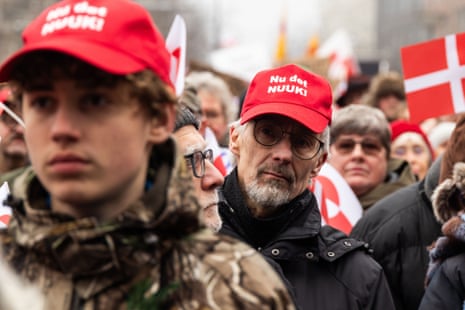 A protester wears the Anti-MAGA cap ''Nu det NUUK!'' during a demonstration under the slogans 'hands off Greenland' and 'Greenland for Greenlanders' at City Hall Square in Copenhagen, Denmark, on January 17, 2026.