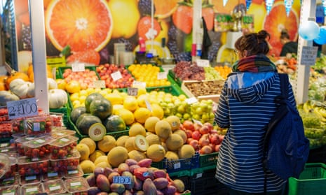 a customer browses a fruit and veg stall