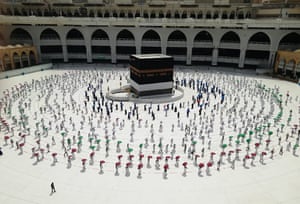 Hundreds of Muslim pilgrims circle the Kaaba, the cubic building at the Grand Mosque, as they observe social distancing to protect themselves against the coronavirus, in the Muslim holy city of Mecca, Saudi Arabia.