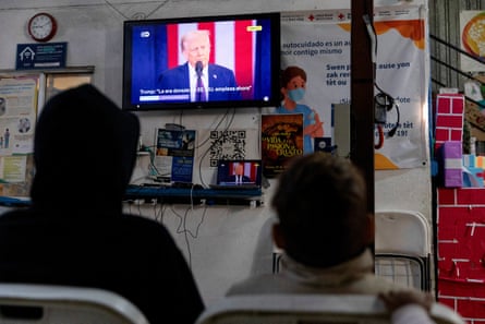 People watch man speaking on TV
