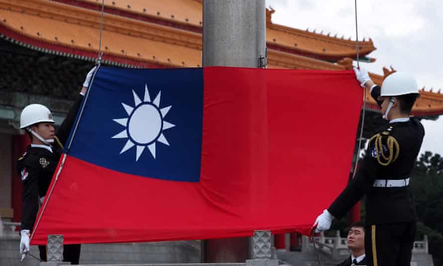 Guards hold a Taiwanese flag