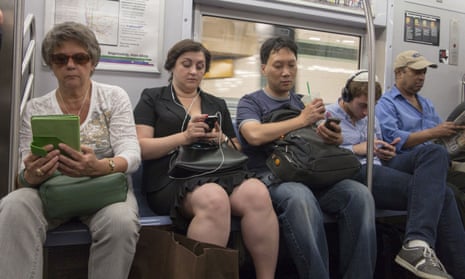 Subway riders on phones/tablets