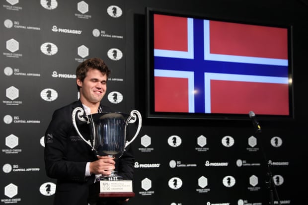 Carlsen celebrates with the trophy.