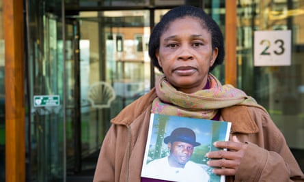 Esther Kiobel poses with a picture of her late husband, one of nine men executed by Nigeria’s military government after a peaceful uprising in 1995 against Shell’s widespread pollution in Ogoniland
