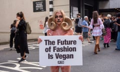 Lucy Ferguson dressed as a goat holds up a placard outside the show space at London fashion week in a protest by Peta about animal suffering in cashmere production.