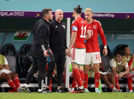 Wales Rob Page talks to Gareth Bale and Aaron Ramsey during the match between Wales and England.