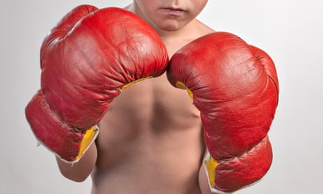 A boy wearing boxing gloves