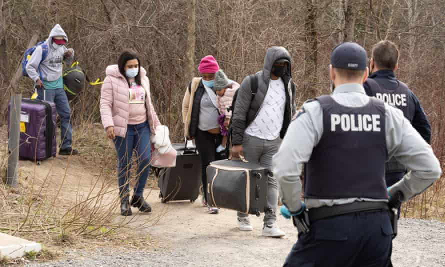 Asylum seekers cross into Canada from the US border near a checkpoint on Roxham Road near Hemmingford, Quebec, last month.