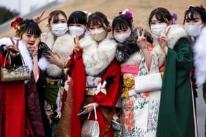 Twenty-year-old women dressed in kimonos pose outside Todoroki Arena in Kawasaki, Kanagawa prefecture