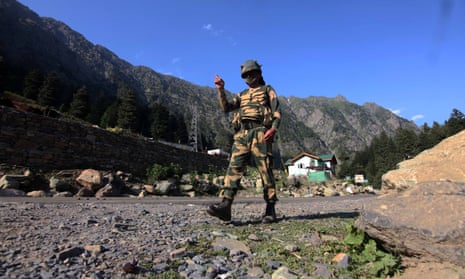 An Indian border security force soldier walks near a check post along the Srinagar-Leh National highway on Tuesday, following deadly clashes along the disputed border with China.