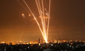 Rockets fired towards Israel from Beit Lahia in the northern Gaza strip light up the night sky on 14 May.