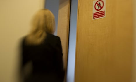 An Internet Watch Foundation analyst enters a room where reported sites are viewed