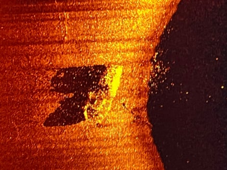 Red and orange sonar image of a ship